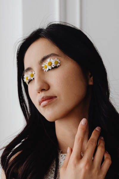Dark circles causes Girl with flowers on eyes